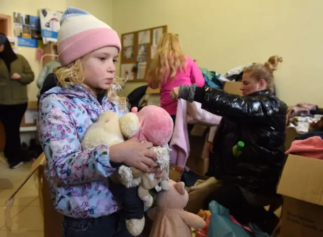 Displaced Ukrainian dentist Yana and her daughter, five-year-old Maya, look for clothes and toys at an aid distribution centre in Ukraines western city of Lviv on April 11, 2022