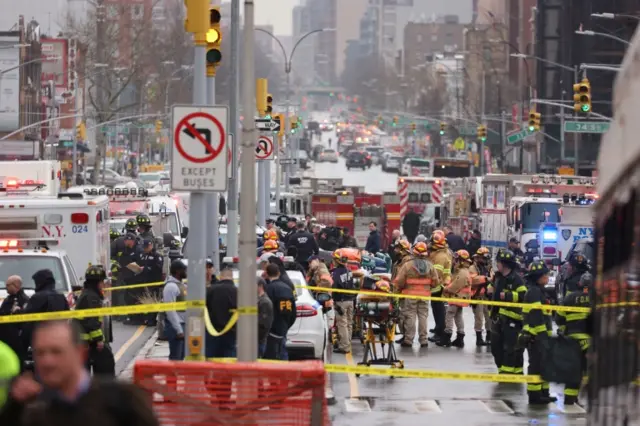 New York City Police and Fire Department officials on the scene of a reported multiple shooting at a New York City Subway station in the Brooklyn borough of New York, New York, USA, 12 April 2022.