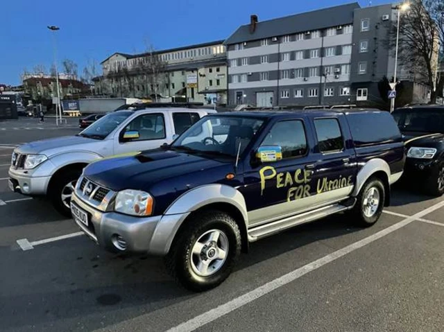 Simon's car, with Peace for Ukraine written on it