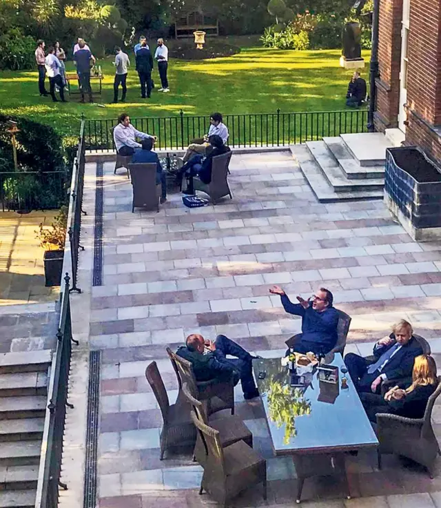 Boris Johnson and staff pictured with wine in Downing Street garden in May 2020.