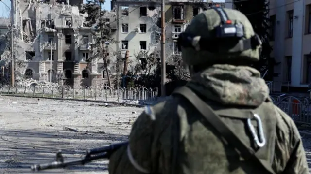 A lone pro-Russia soldier by the ruins of a damaged building, Mariupol,