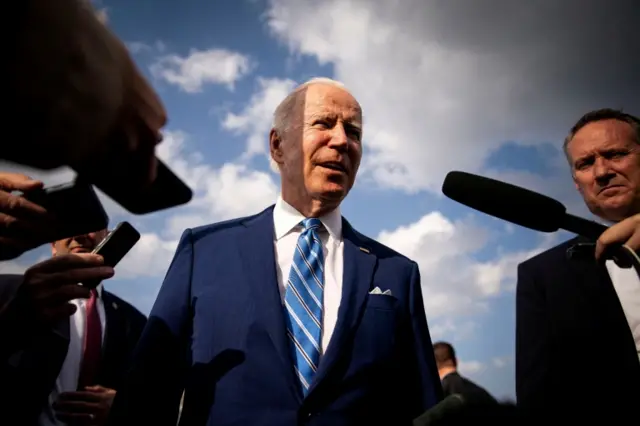 President Biden speaks to reporters while departing from Des Moines airport