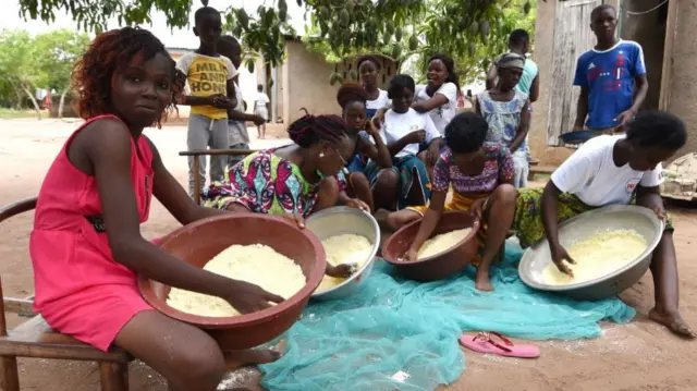 Women from the Baoulé community cook attieke in Assounvoue village, central Ivory Coast, on the eve of "Paquinou" - 2018