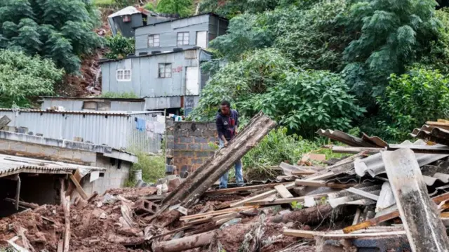 Residents salvage the remains of what use to be the United Methodist Church of South Africa in Clermont, near Durban - 13 April 2022