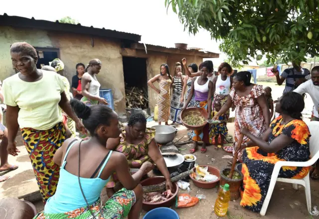 Women from the Baoulé community prepare food Assounvoue village, central Ivory Coast, on the eve of "Paquinou" - 2018