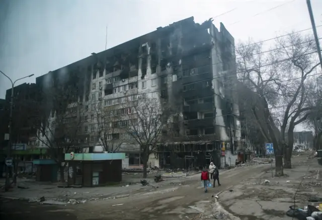 A picture taken during a visit to Mariupol organised by the Russian military shows a burned-out apartment building in central Mariupol, Ukraine, on 12 April 2022