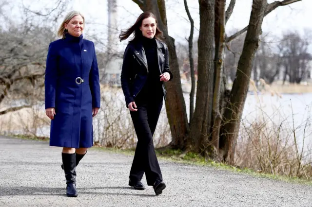 Swedish Prime Minister Magdalena Andersson walks with Finnish PM Sanna Marin