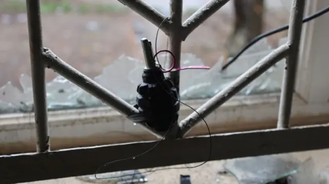 A grenade seen tied to a window