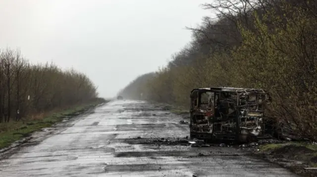 A destroyed van on the road in Poposna