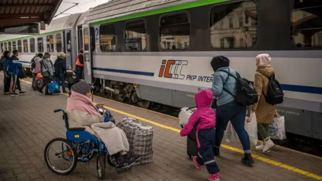 An elderly evacuee waits for a train in Poland