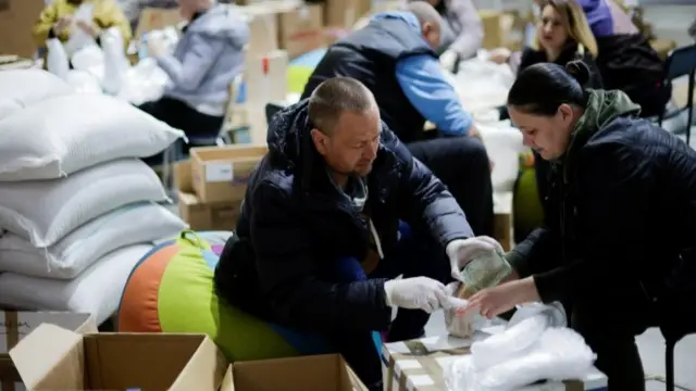 Ukrainian volunteers prepare to deliver food inside a complex, set up as a shelter, amid Russia's invasion of Ukraine, in Zaporizhzhya