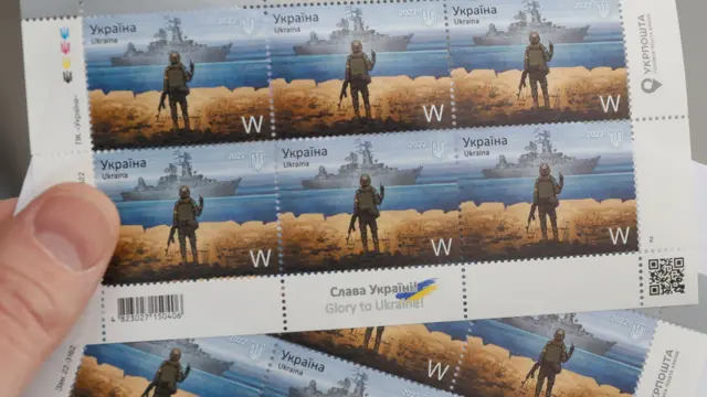 Postage stamps show a Ukrainian service member and the Russian warship