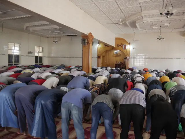 A photo of people praying inside a mosque in Kigali.