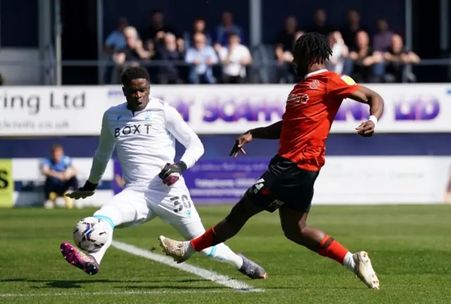 Luton's Fred Onyedinma shoots at goal as Nottingham Forest goalkeeper Brice Samba saves with his foot