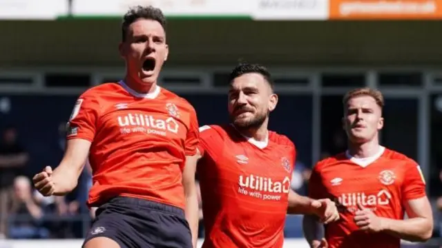 Kal Naismith celebrates scoring from the spot for Luton