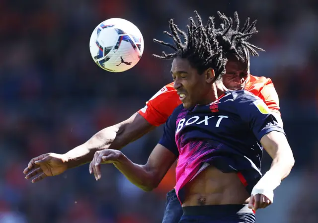 Djed Spence of Nottingham Forest win a header in front of Luton's Fred Onyedinma