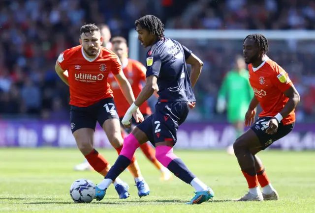 Djed Spence of Nottingham Forest is challenged by Luton's Robert Snodgrass (left) and Fred Onyedinma