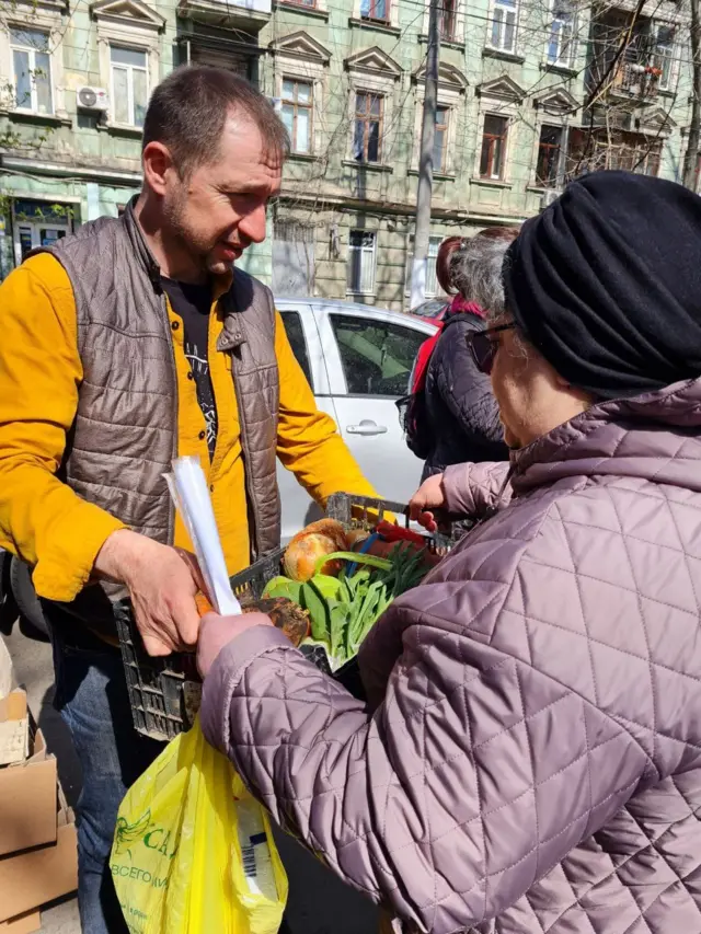 Alexander Pavlovsky delivering a food parcel