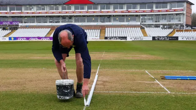 Groundstaff prepare the pitch at the Riverside