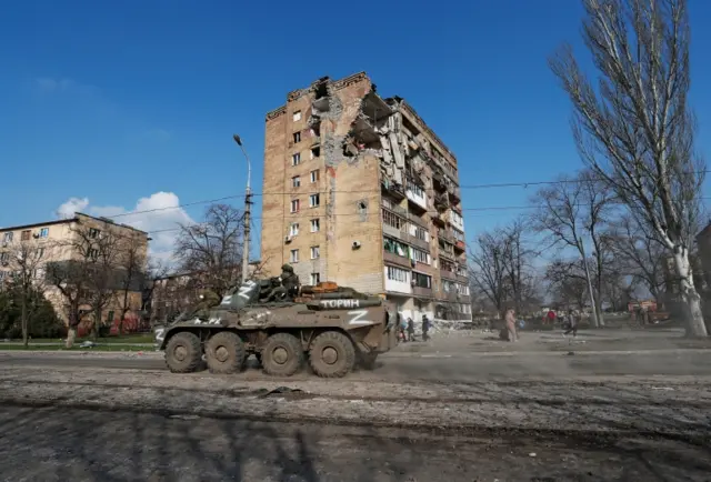 Pro-Russian troops ride an armoured personnel carrier in Mariupol