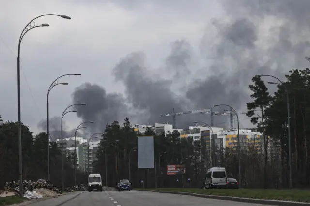 Smoke rises over the outskirts of Kyiv