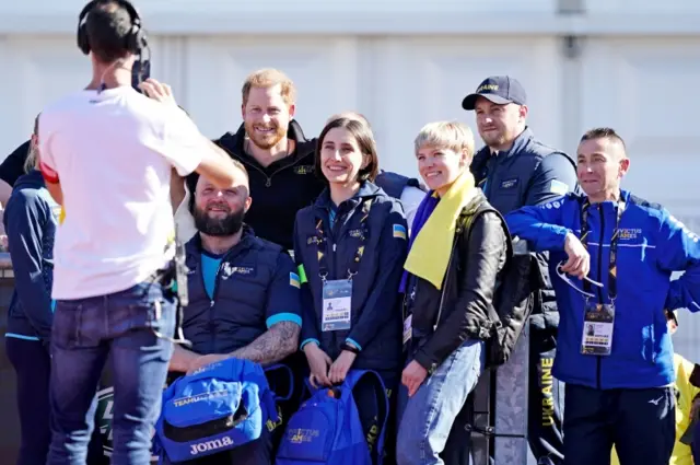 Prince Harry taking pictures with Ukrainian veterans at the Invictus Games