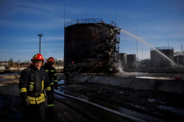 Firefighters operate at a damaged oil depot following a Russian missile attack in Lviv in late March