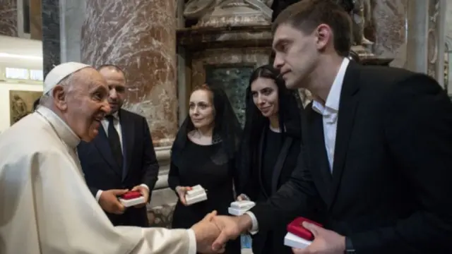 Pope Francis shakes hands with mayor of Ukrainian city of Melitopol Ivan Fedorov next to members of Ukrainian parliament Maria Mezentseva, Olena Khomenko and Rustem Umerov, , as they attend the Easter Vigil in Saint Peter"s Basilica at the Vatican, 16 April 2022