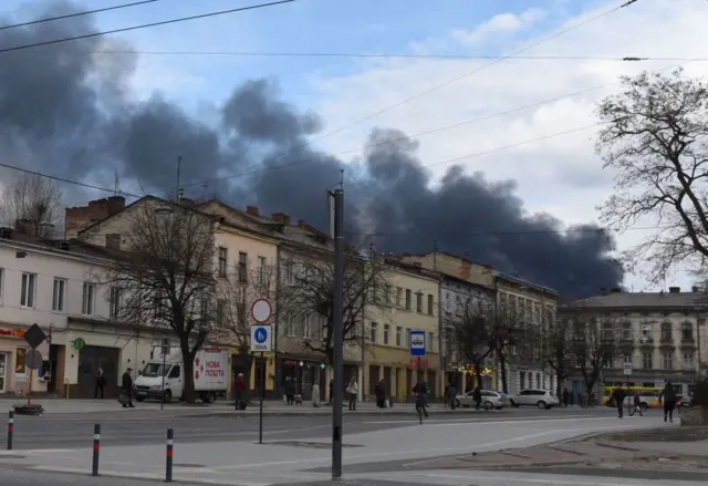 Dark smoke rises following an air strike in the western Ukrainian city of Lviv,