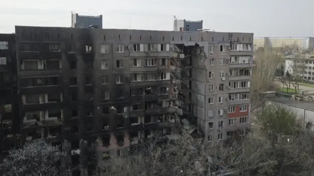 Drone image of a damaged residential building in Mariupol