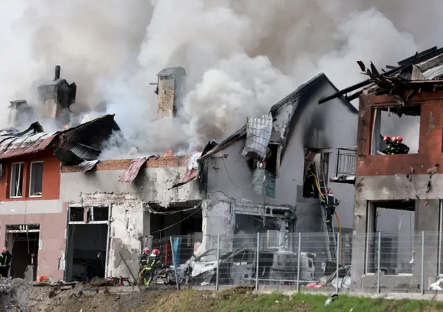 Firefighters battle a blaze after a civilian building was hit by a Russian missile on April 18, 2022 in Lviv, Ukraine.