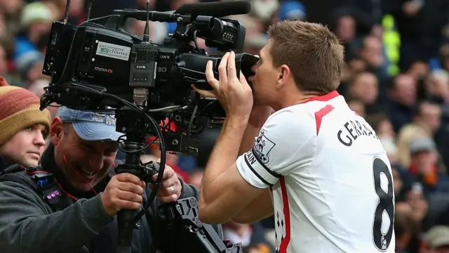 Steven Gerrard kisses a camera