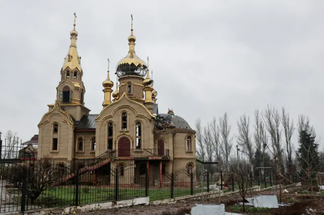 An orthodox church damaged by shelling in Maryinka