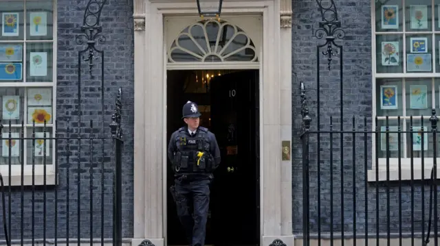 A police officer leaves Downing Street