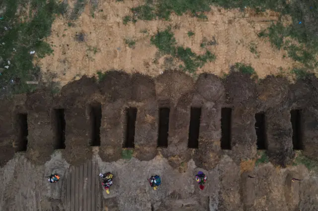 Freshly dug graves are seen at the cemetery on April 18, 2022 in Bucha, Ukraine.