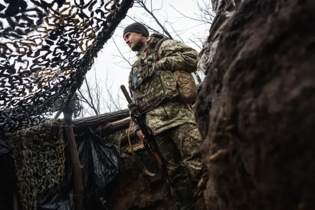 A Ukrainian serviceman is seen on the frontline in Donbas, Ukraine