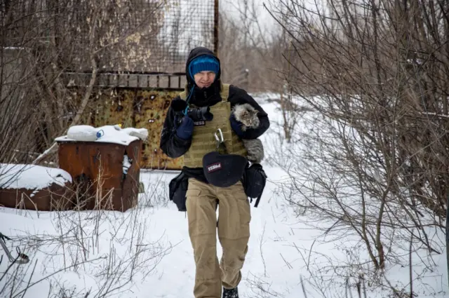 Levin carries a cat in the Donetsk region of Ukraine