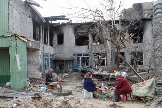 Group in gutted children's home, Mariupol, 1 April 22