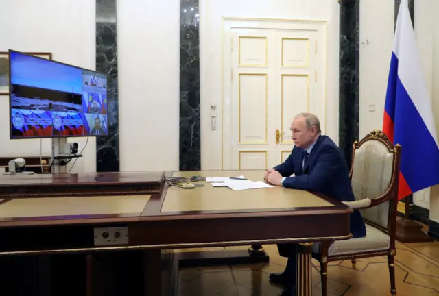 President Putin watches a test launch of a ballistic missile on a screen in Moscow