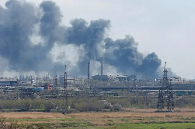 Smoke rises above a plant of Azovstal Iron and Steel Works in Mariupol 20 April 2022