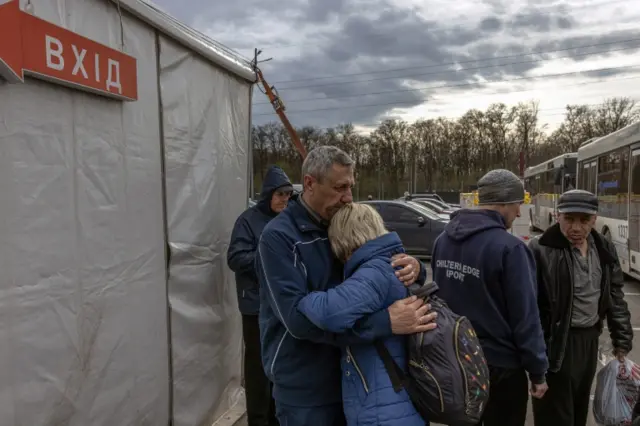 People from Mariupol react after arriving on an evacuation bus to the evacuation point in Zaporizhzhia