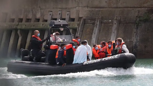 A Border Force vessel brings a group of men into Dover