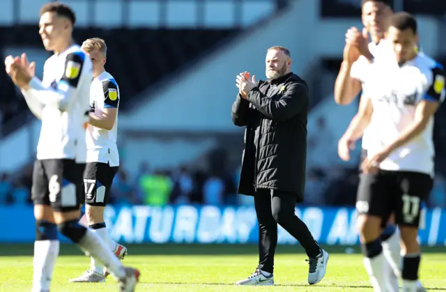 Wayne Rooney with his Derby players on the pitch