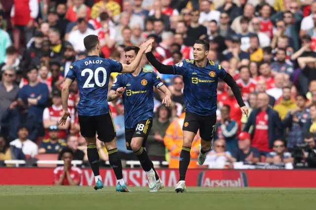 Cristiano Ronaldo celebrates after scoring a penalty against Arsenal