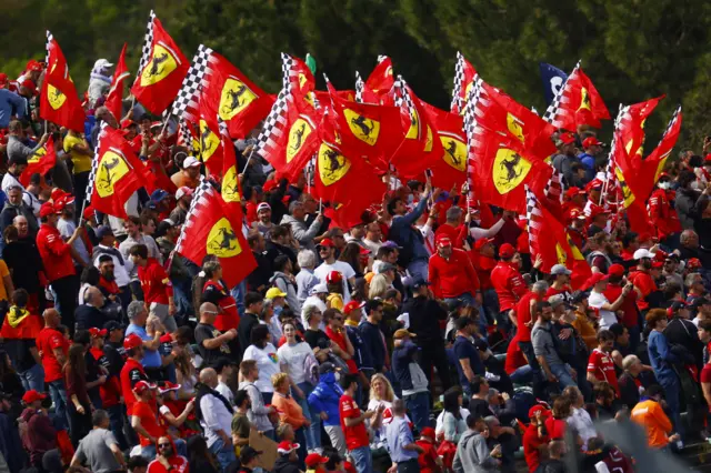 Packed stand full of fans waving Ferrari flags at Imola