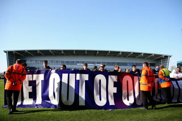 Oldham fans protest on the pitch