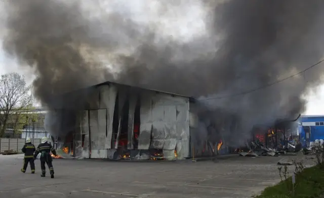 Firefighters at the scene of a fire caused by shelling in Kharkiv in the northeast