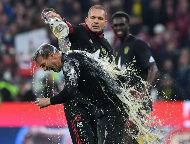 Bayern Munich players throw beer over their manager