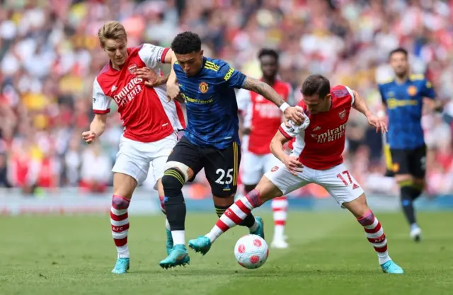 Jadon Sancho runs against the Arsenal defence