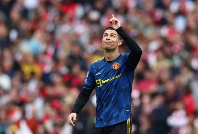 Cristiano Ronaldo points to the sky after scoring against Arsenal